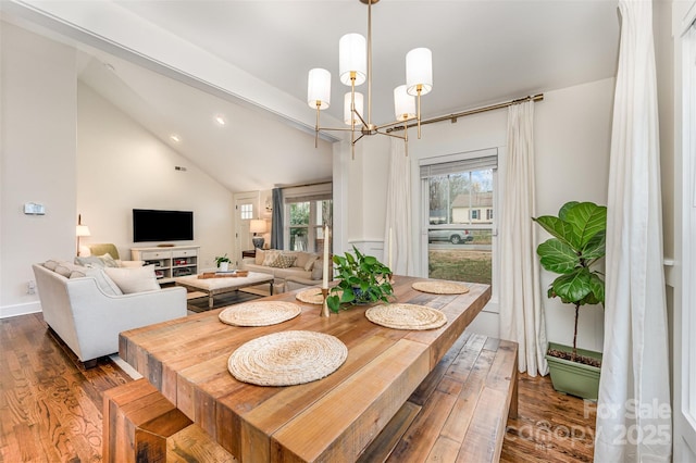 dining room featuring lofted ceiling, dark wood-type flooring, and a notable chandelier