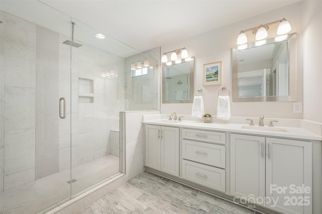 bathroom featuring vanity and a shower with shower door