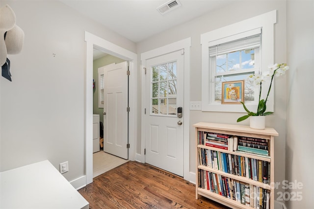 entryway with dark hardwood / wood-style flooring and washer / dryer