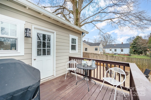 wooden deck featuring a grill