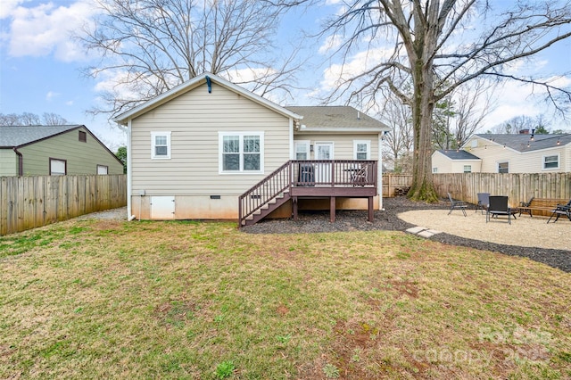 back of house featuring a wooden deck, a yard, and a patio