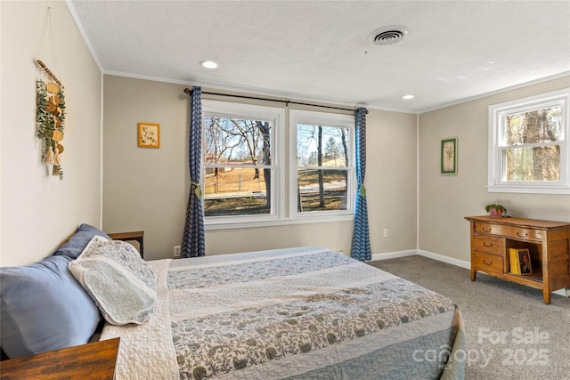 carpeted bedroom featuring crown molding and a textured ceiling