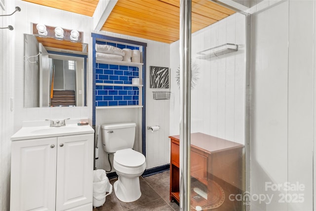 bathroom featuring vanity, tile patterned floors, wood ceiling, and toilet