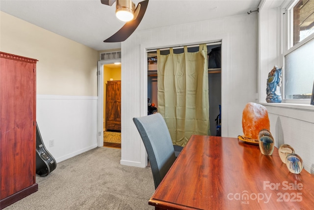 office area with ceiling fan and light carpet