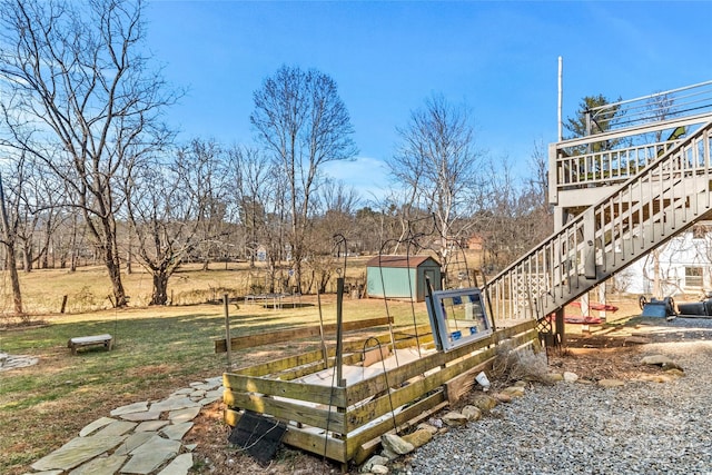 view of yard featuring a rural view and a storage shed