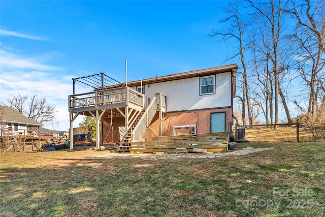 back of property featuring central AC unit, a deck, and a lawn