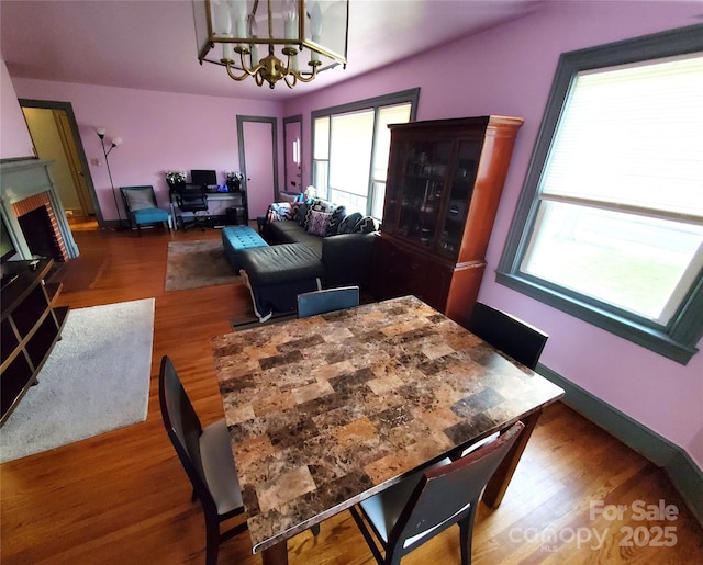 dining space with wood-type flooring and a chandelier