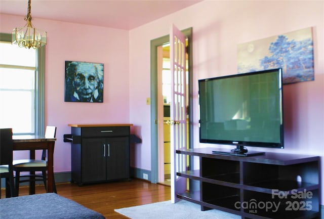 living room featuring hardwood / wood-style floors, a notable chandelier, and plenty of natural light