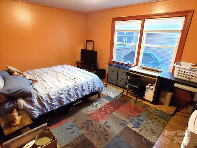 bedroom with hardwood / wood-style flooring