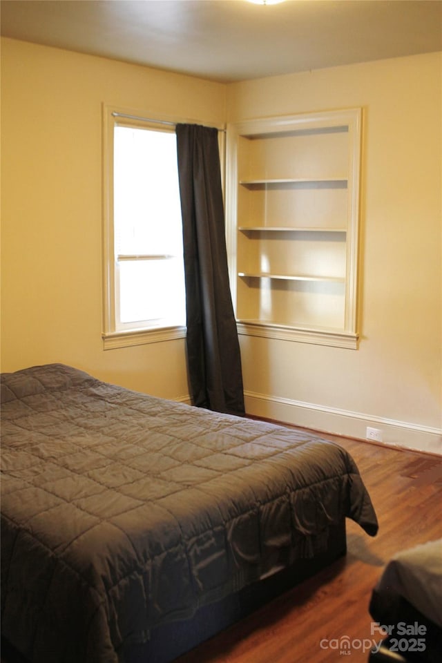 bedroom with hardwood / wood-style floors