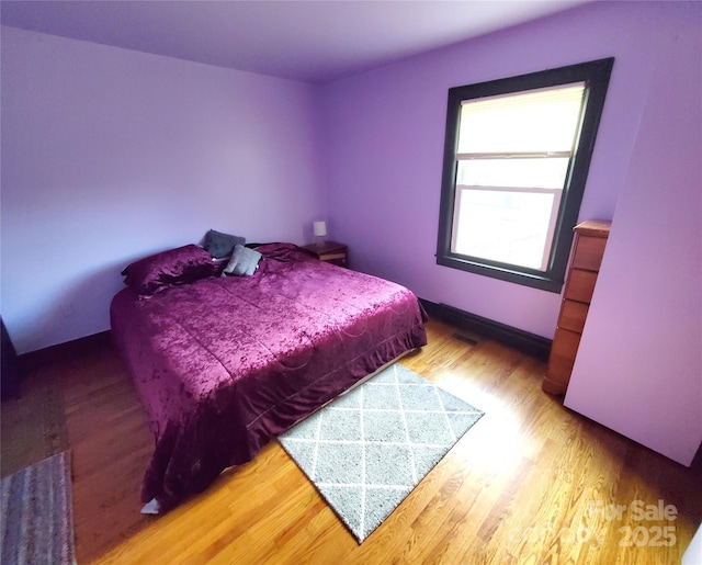 bedroom with hardwood / wood-style flooring