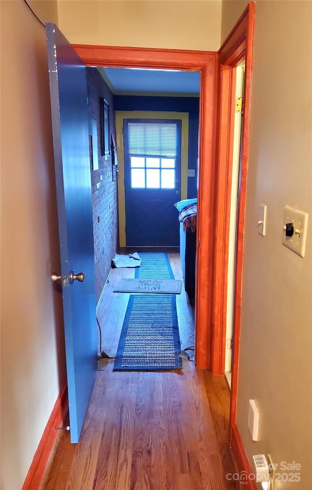 hallway with wood-type flooring