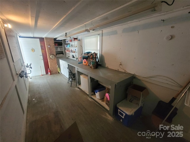 basement with hardwood / wood-style floors and a workshop area