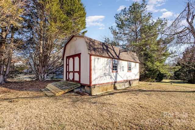 view of outbuilding with a yard