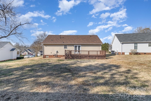 back of house featuring a wooden deck and a lawn