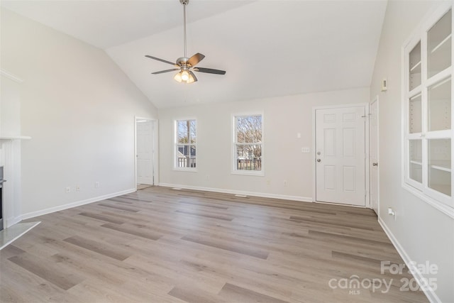 unfurnished living room featuring vaulted ceiling, ceiling fan, and light wood-type flooring