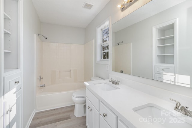 full bathroom featuring vanity, hardwood / wood-style floors, tub / shower combination, and toilet