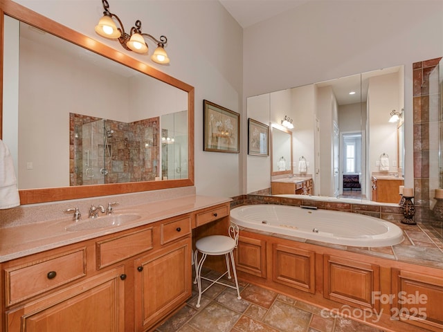 bathroom featuring plus walk in shower and vanity