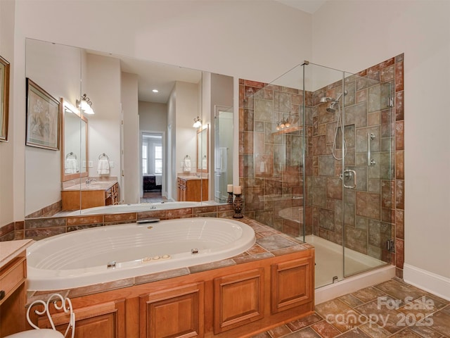 bathroom featuring tile patterned flooring, vanity, and shower with separate bathtub