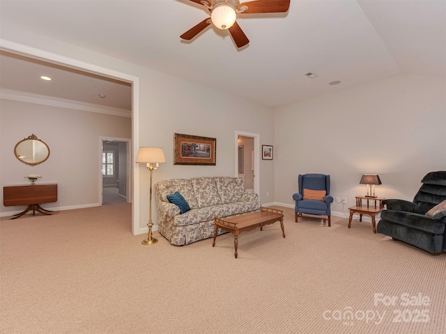 living room featuring ornamental molding, lofted ceiling, carpet floors, and ceiling fan