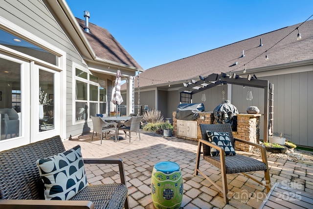 view of patio / terrace featuring area for grilling and a pergola