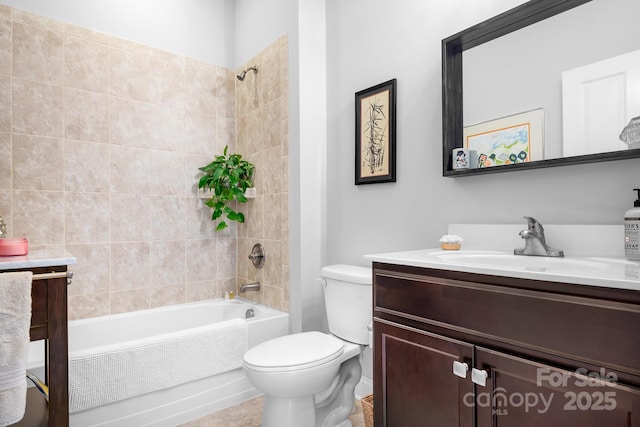 full bathroom featuring vanity, tiled shower / bath, and toilet