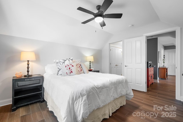 bedroom with ceiling fan, lofted ceiling, and a closet