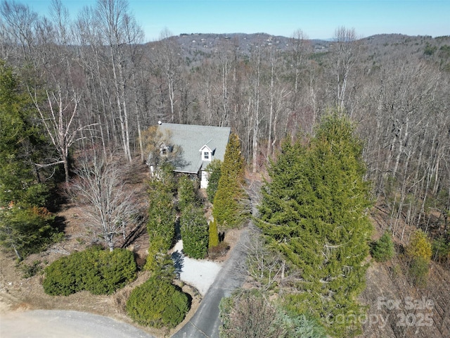 birds eye view of property with a wooded view