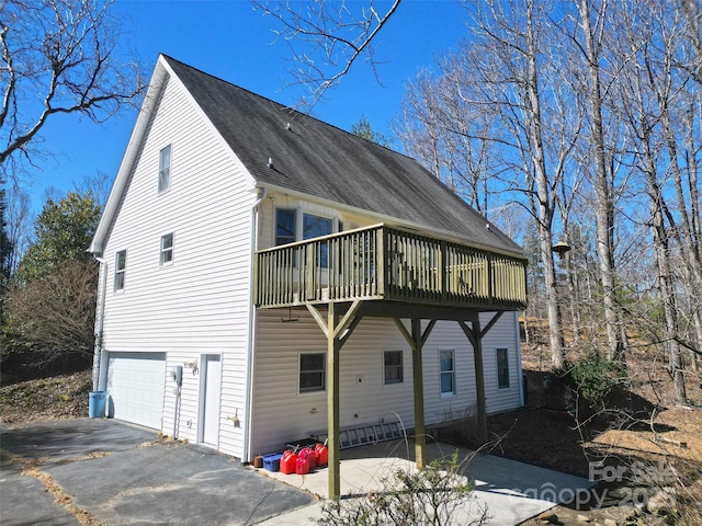 view of side of home with driveway and a garage