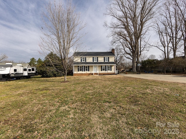 view of front of house with a porch and a front yard