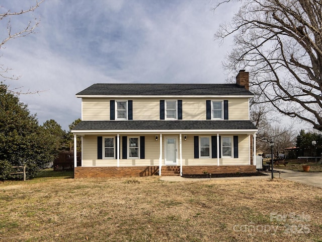 view of front of home featuring a front yard and covered porch