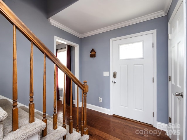 entrance foyer with crown molding and dark wood-type flooring