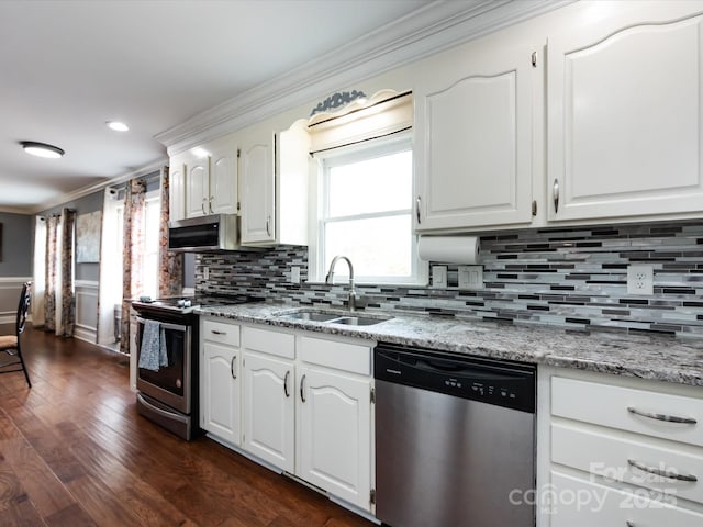 kitchen with white cabinetry, appliances with stainless steel finishes, sink, and crown molding