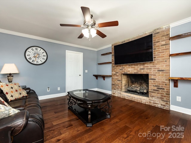 living room featuring crown molding, a brick fireplace, dark hardwood / wood-style floors, and ceiling fan