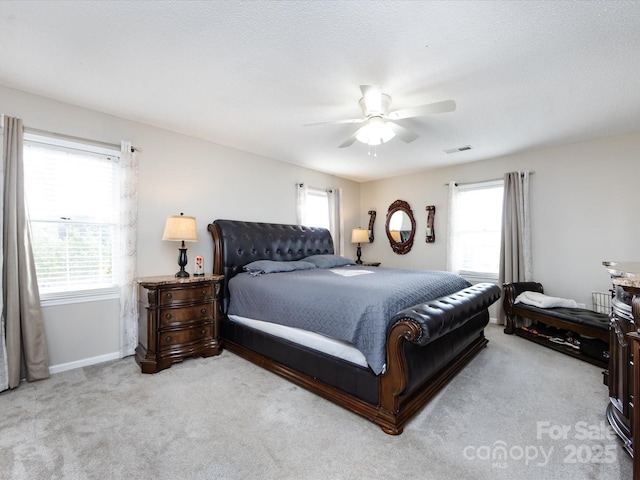 bedroom featuring light carpet and ceiling fan