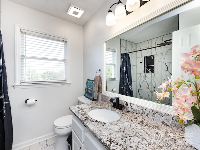 bathroom with walk in shower, vanity, and toilet