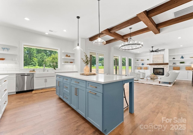 kitchen with white cabinetry, stainless steel dishwasher, decorative backsplash, and hanging light fixtures