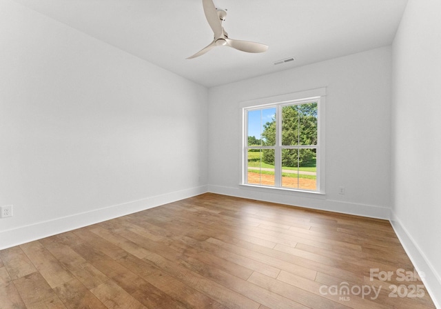 unfurnished room with hardwood / wood-style floors and ceiling fan