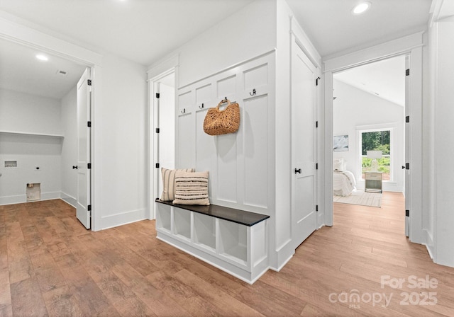 mudroom with lofted ceiling and light hardwood / wood-style floors