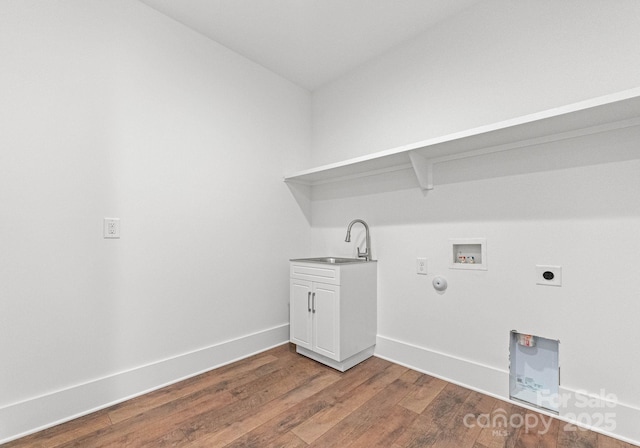 laundry room with sink, cabinets, hookup for a washing machine, hookup for an electric dryer, and hardwood / wood-style floors