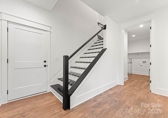 stairs featuring hardwood / wood-style flooring