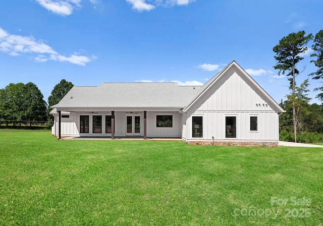 rear view of house with a yard, a patio area, and french doors