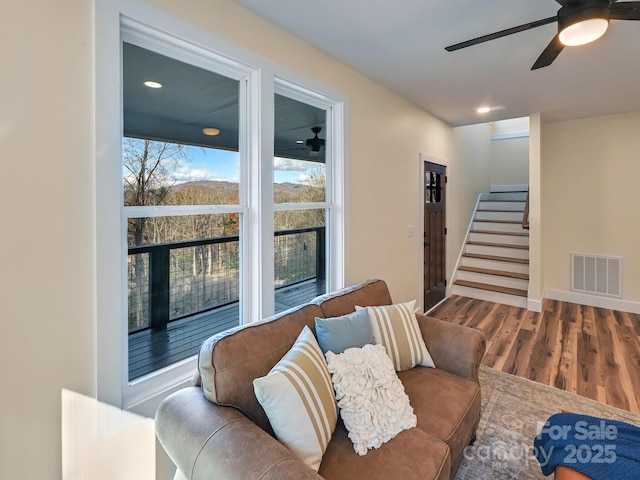 living room featuring hardwood / wood-style flooring and ceiling fan