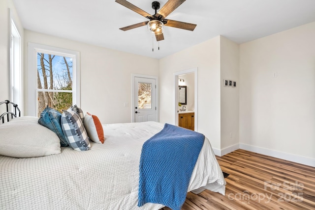 bedroom with hardwood / wood-style floors, sink, ceiling fan, and ensuite bathroom