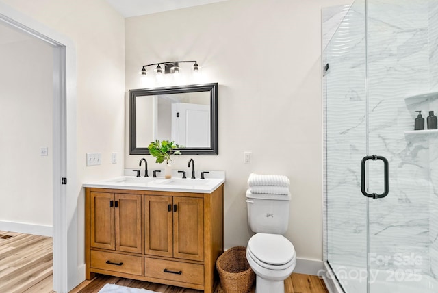 bathroom featuring vanity, toilet, hardwood / wood-style floors, and walk in shower