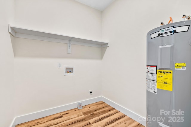 clothes washing area with hardwood / wood-style floors, hookup for an electric dryer, hookup for a washing machine, and water heater