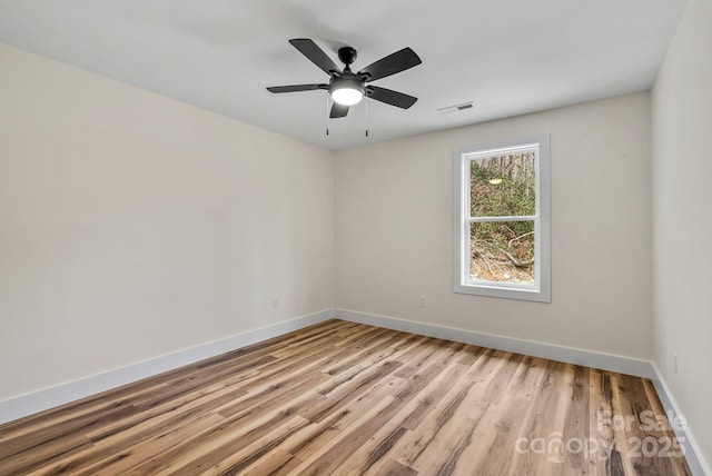 spare room featuring ceiling fan and light hardwood / wood-style floors