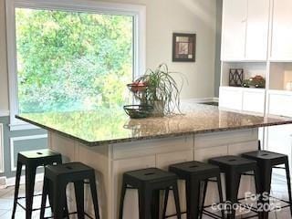 kitchen with white cabinets and light stone counters