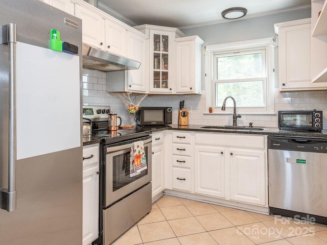 kitchen with sink, appliances with stainless steel finishes, white cabinetry, ornamental molding, and decorative backsplash