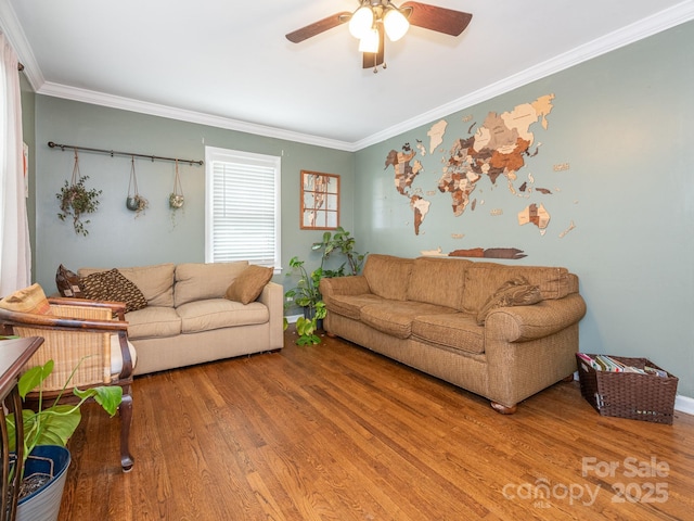 living room with hardwood / wood-style flooring, ceiling fan, and crown molding